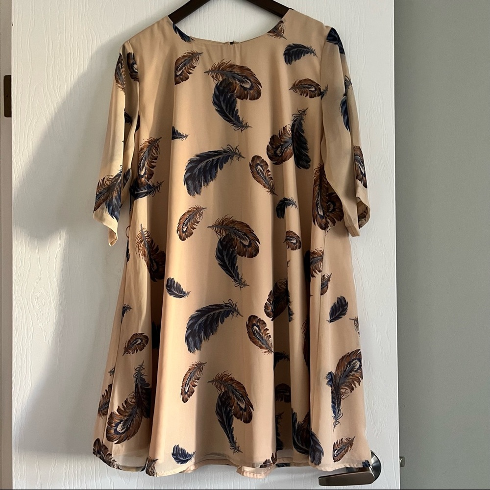 Feathered and cream loose A-line dress perfect for belting or wearing loose.